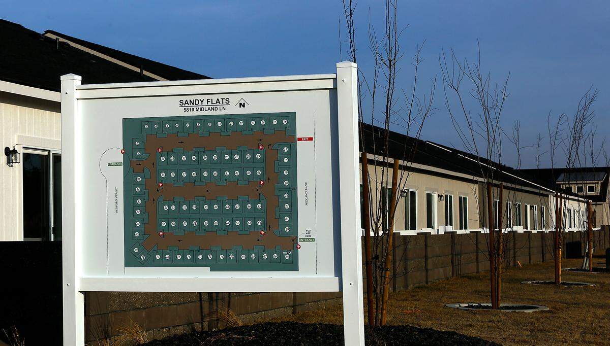 A sign shows the layout for the partially completed 84-unit duplex project by Big Sky Developers called Sandy Flats.