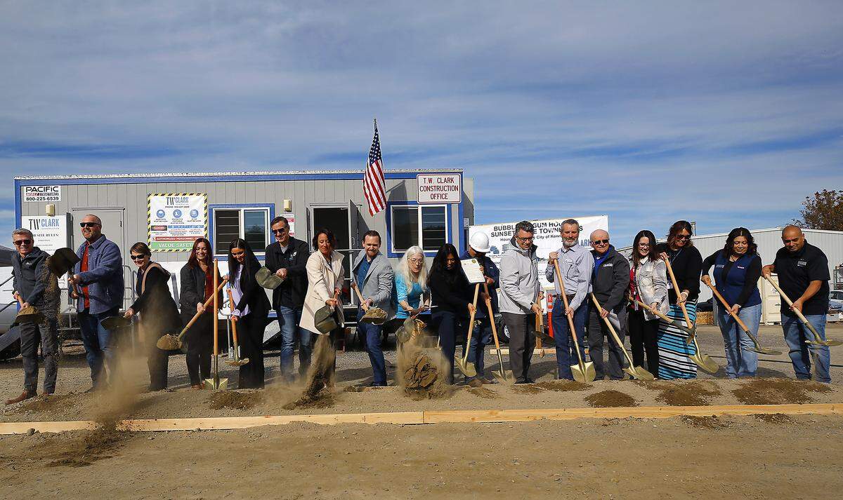 About 30 people joined in the groundbreaking for the new Sunset Ridge Townhomes project by the Kennewick Housing Authority on South Gum Street.