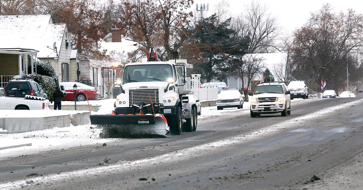A city of Kennewick snowplow scrapes snow and slush from the eastbound lanes of East First Avenue Tuesday morning in downtown Kennewick. Snow removal crews were busy around the Mid-Columbia after a winter storm dropped an estimated 1-2 inches of snow.