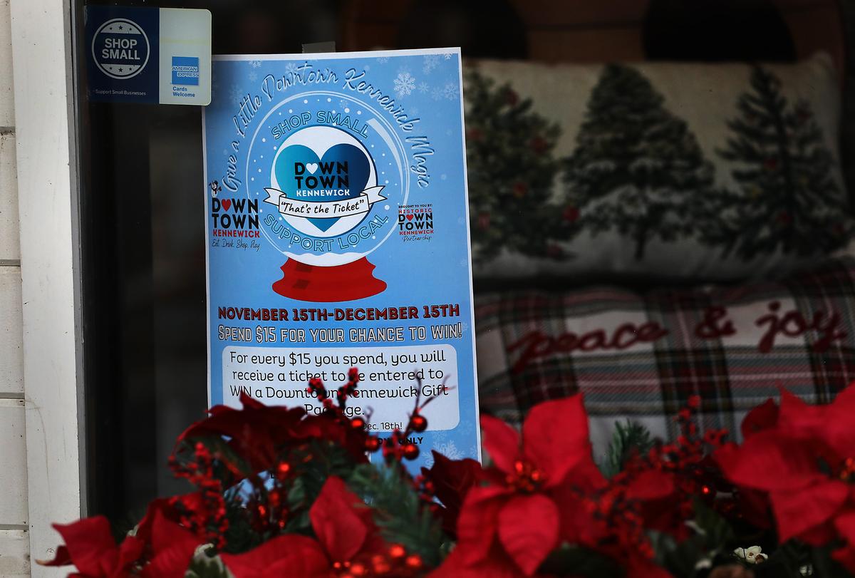 A “That’s the Ticket” poster is displayed in the window of a shop located in downtown Kennewick for the 2024 holiday shopping season.