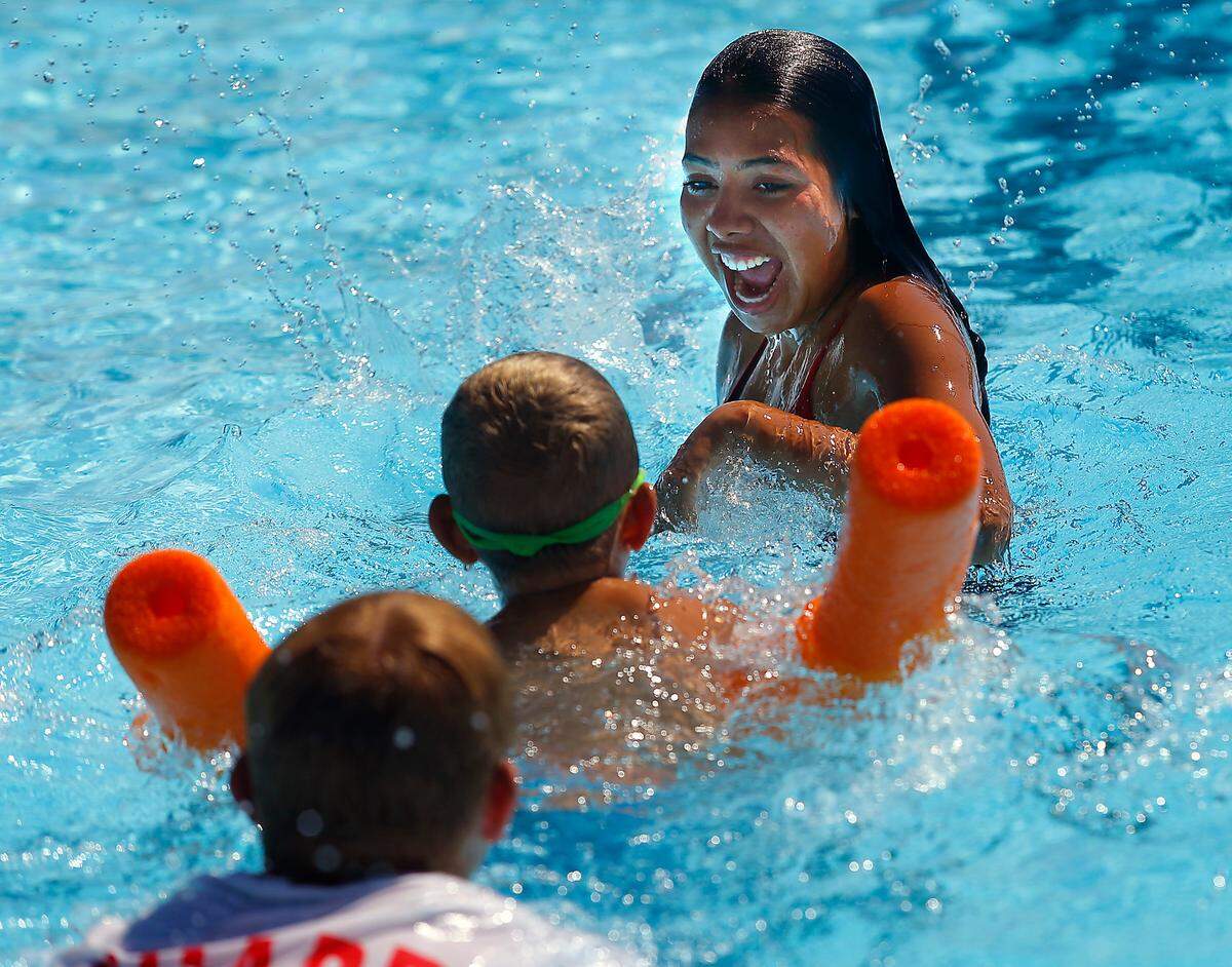 Lifeguard Evelyn Uzarraga takes part in a playful game of tag during swim lessons recently at the Kenneth E. Serier Memorial Pool in downtown Kennewick.&nbsp;The swim students were given flotation noodles to help navigate in the water during the session.&nbsp;The city pool is currently only open for swim lessons and lap swimming sessions.&nbsp;