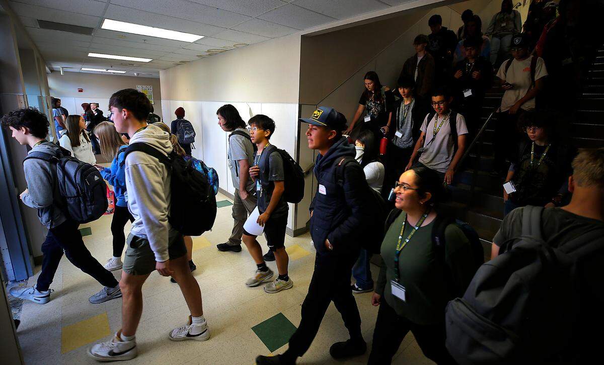 Richland High School students navigate congestion on the stairwell in Mac Hall, the building with math and science classrooms, during a class change. They walk out a recently install doorway added to alleviate the “traffic jam.”
