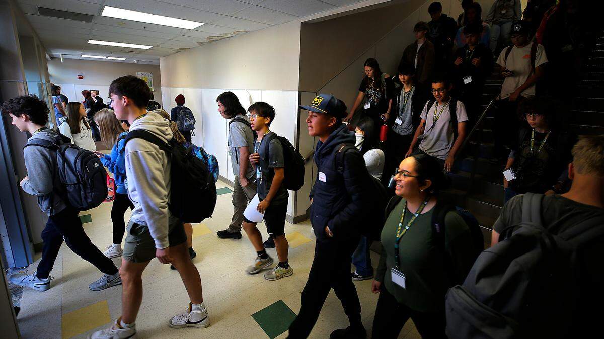 Richland High School students navigate congestion on the stairwell in Mac Hall, the building with math and science classrooms, during a class change. They walk out a recently install doorway added to alleviate the “traffic jam.”
