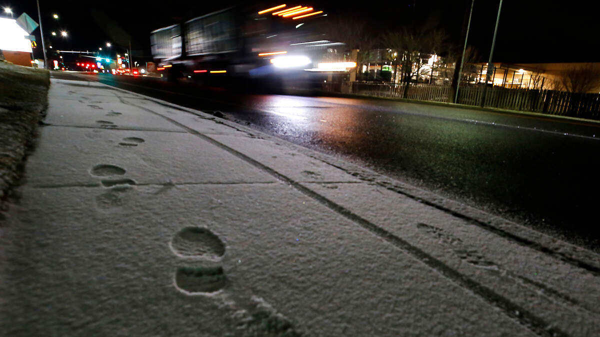 Footprints and bicycle tire tracks show up early Tuesday morning on the sidewalk along West 27th Avenue near South Olson Street in Kennewick following an overnight dusting of snow in the Tri-Cities.