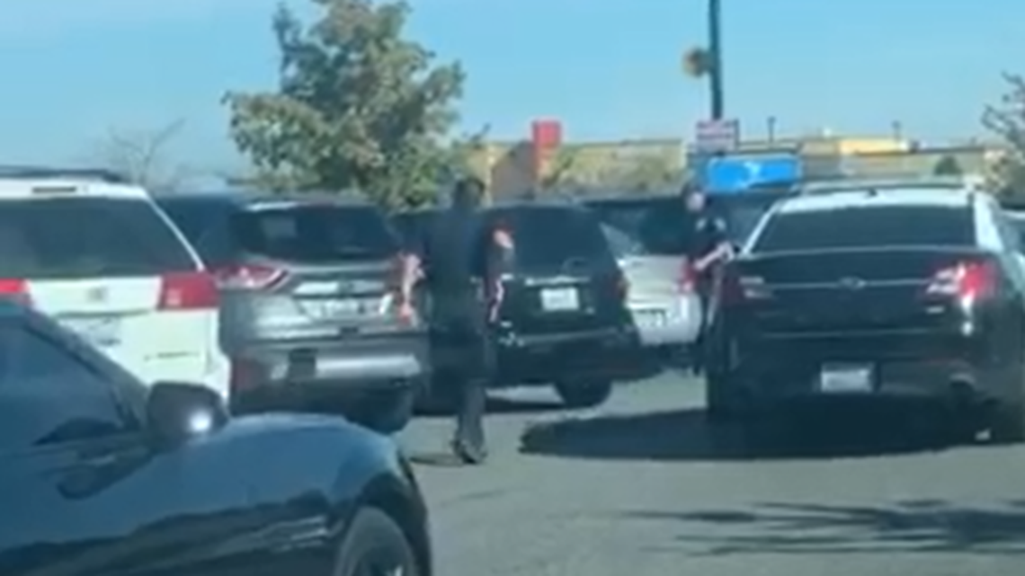Kennewick police officers try to stop a stolen Chevy HHR in the Walmart parking lot Saturday.