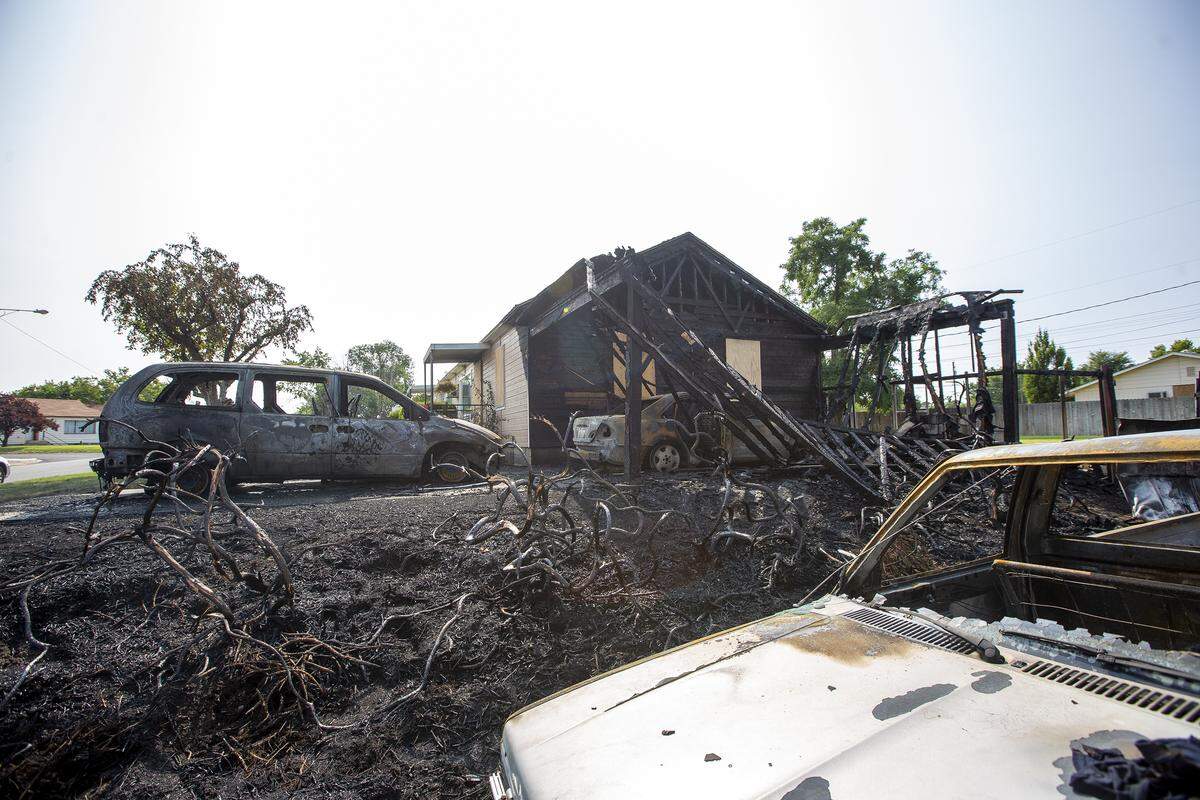 Aftermath of a fire burning two duplexes on the 1100 block Benham Street in Richland. Four cars were damaged.