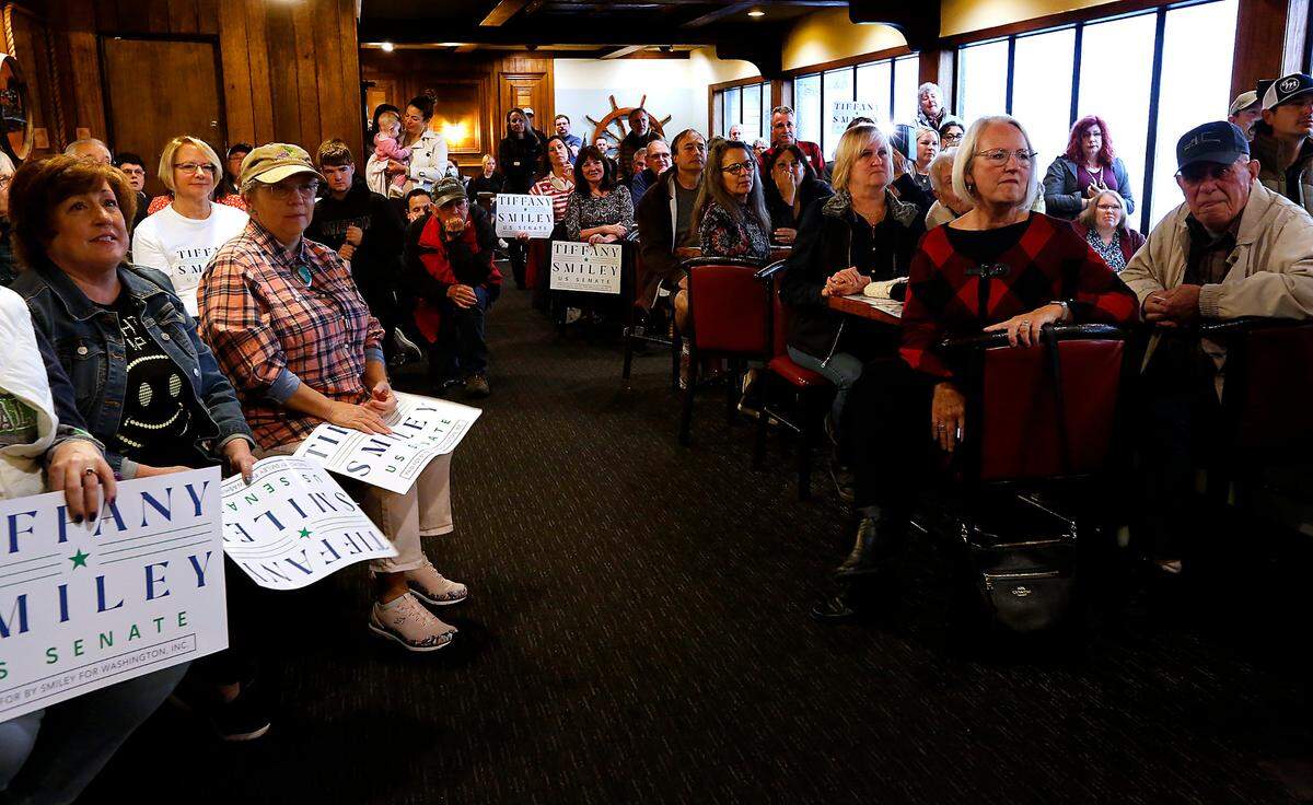 Chased inside by rainy weather, supporters of U.S. Senate Candidate Tiffany Smiley sit the restaurant of the Clover Island Inn Tuesday morning during her stop in Kennewick.