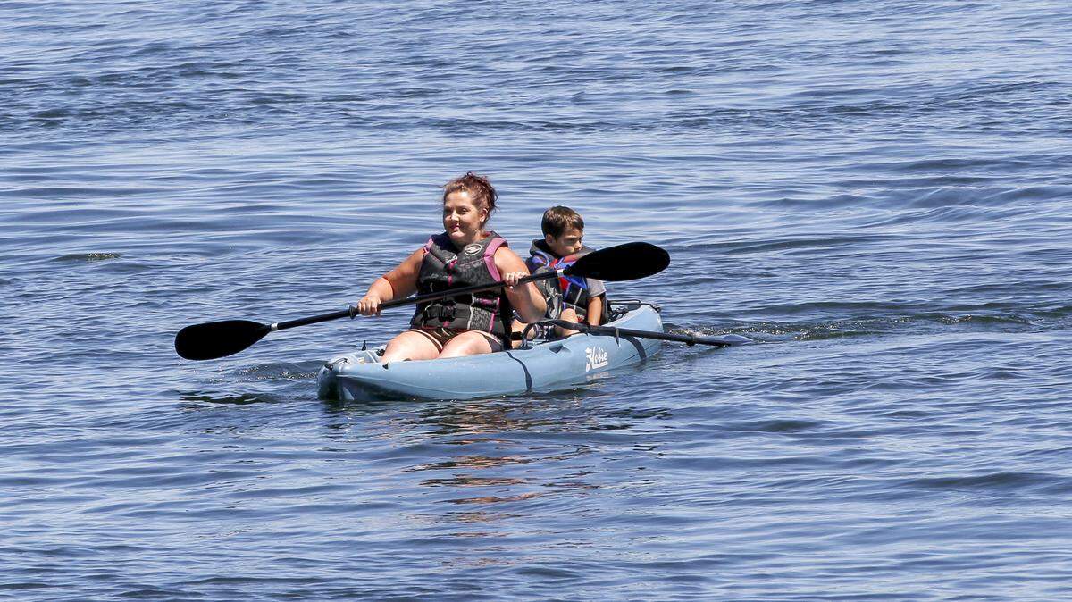 Kiersten Ramirez Cruz of West Richland kayaks with her son, Cruz, in the Columbia River near Howard Amon Park in Richland. The National Weather Service says it's going to be dry and hot in the Tri-Cities this weekend.