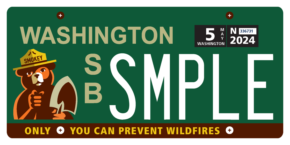 A sample Washington state license plate pays tribute to Smokey Bear. The special plate, which will benefit the Washington State Department of Natural Resources, will be available soon but may look different upon finalization. 