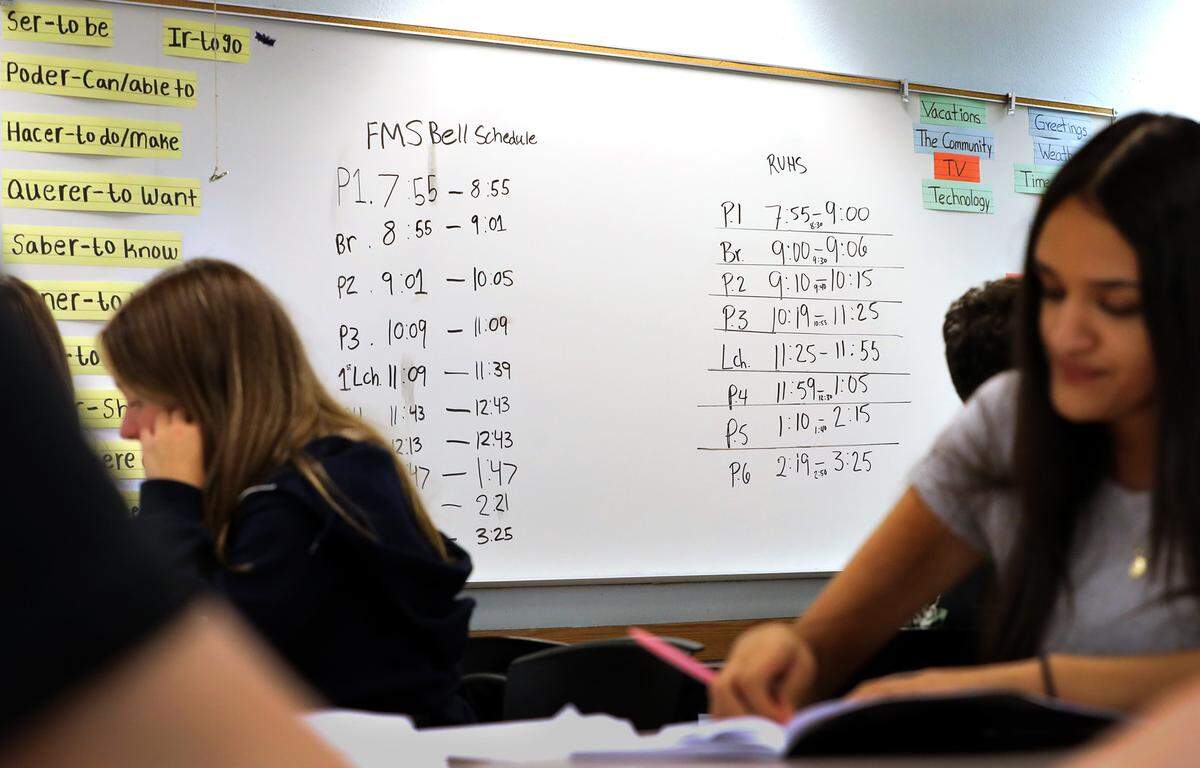 The bell schedules are posted on a dry-erase board for students to reference in a classroom at River View High School in Finley after the school district switched to a four-day school schedule this year.