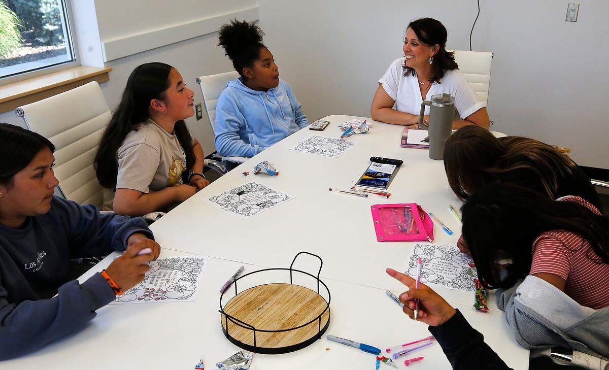 Jenny Vollmer, director of behavioral health, meets with a small group of fith and sixth grade girls recently at the Kennewick clubhouse for the Boys & Girls Clubs of Benton and Franklin Counties. The weekly meetings are designed to give a safe space to talk about their feeling and provide tools for coping with anxious feelings.