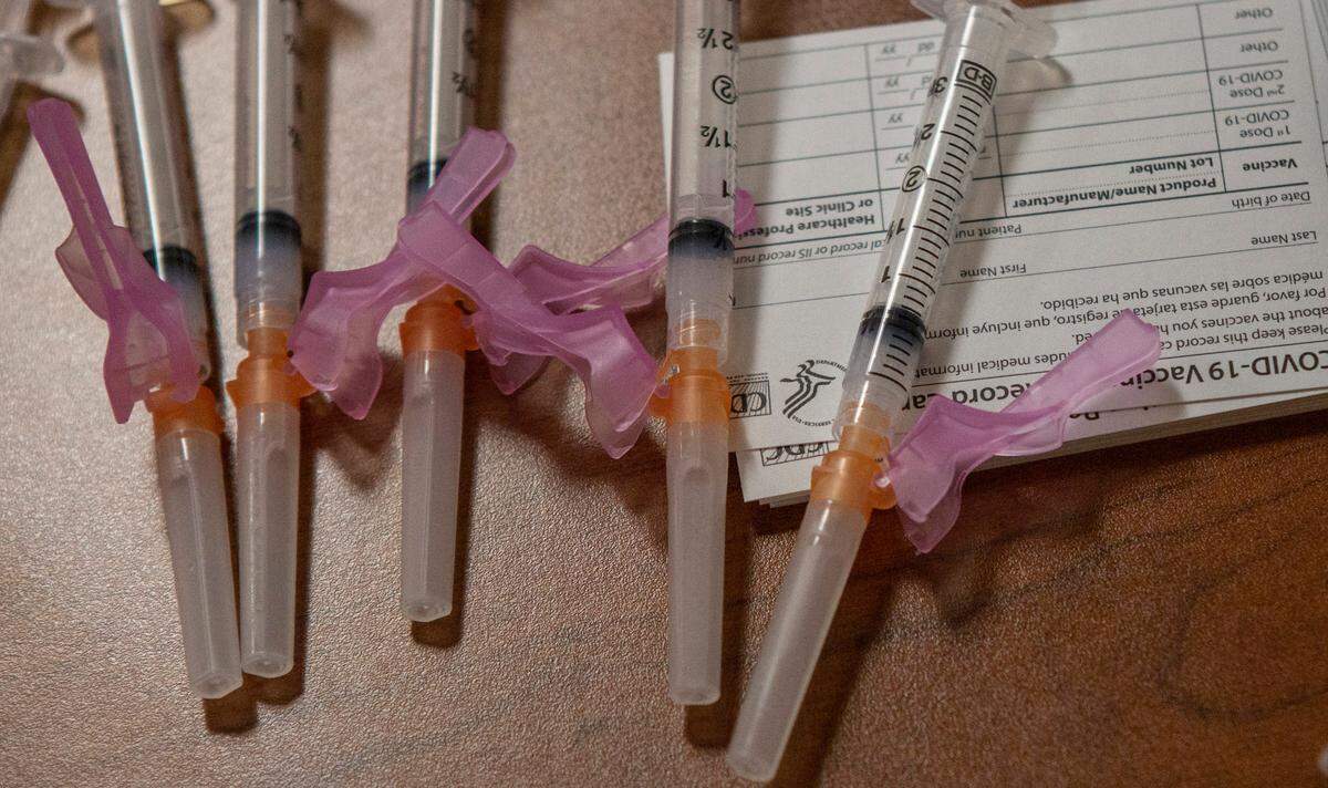 COVID-19 vaccines are placed out in preparation to be administered during a vaccination clinic at Tri-Cities Community Health in Pasco on Friday.