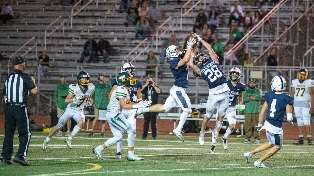Chiawana High’s Braxton Feldmann (28) and Hunter Azure-Pryce (7) reach for the reception on Friday night against the Richland Bombers. Chiawana won 39-27.