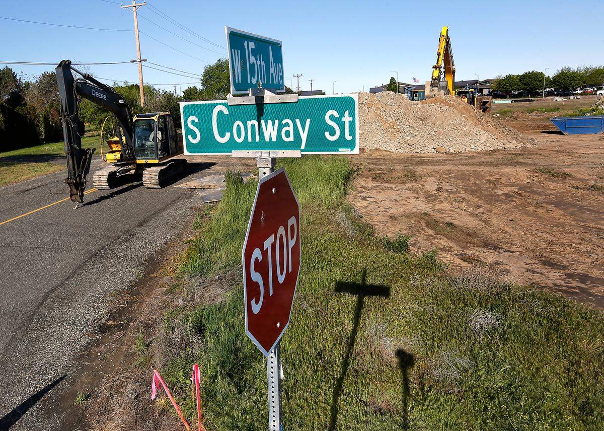 Heavy construction equipment works on preparing the site near Zintel Canyon for a new apartment complex.
