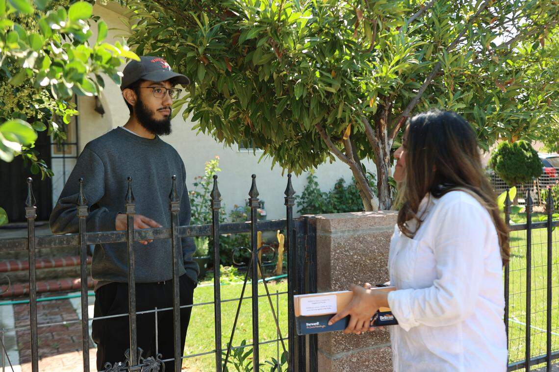 Washington state Senate candidate Maria Beltran speaks with a law student at his family’s home in Toppenish, while campaigning in the Yakima Valley.