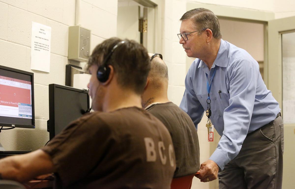 Charles Wheaton, a part-time chaplain at the Benton County Jail, helps inmates enrolled in the Redirection Pod training program with a computer typing skills exercise. The jail training program is designed help inmates make better choices when they’re released. The class topics range from financial literacy, typing skills, and even a GED program. The inmates sign a contract agreeing to a minimum of 25 hours of study time per week. Watch a video at: tricityherald.com/video