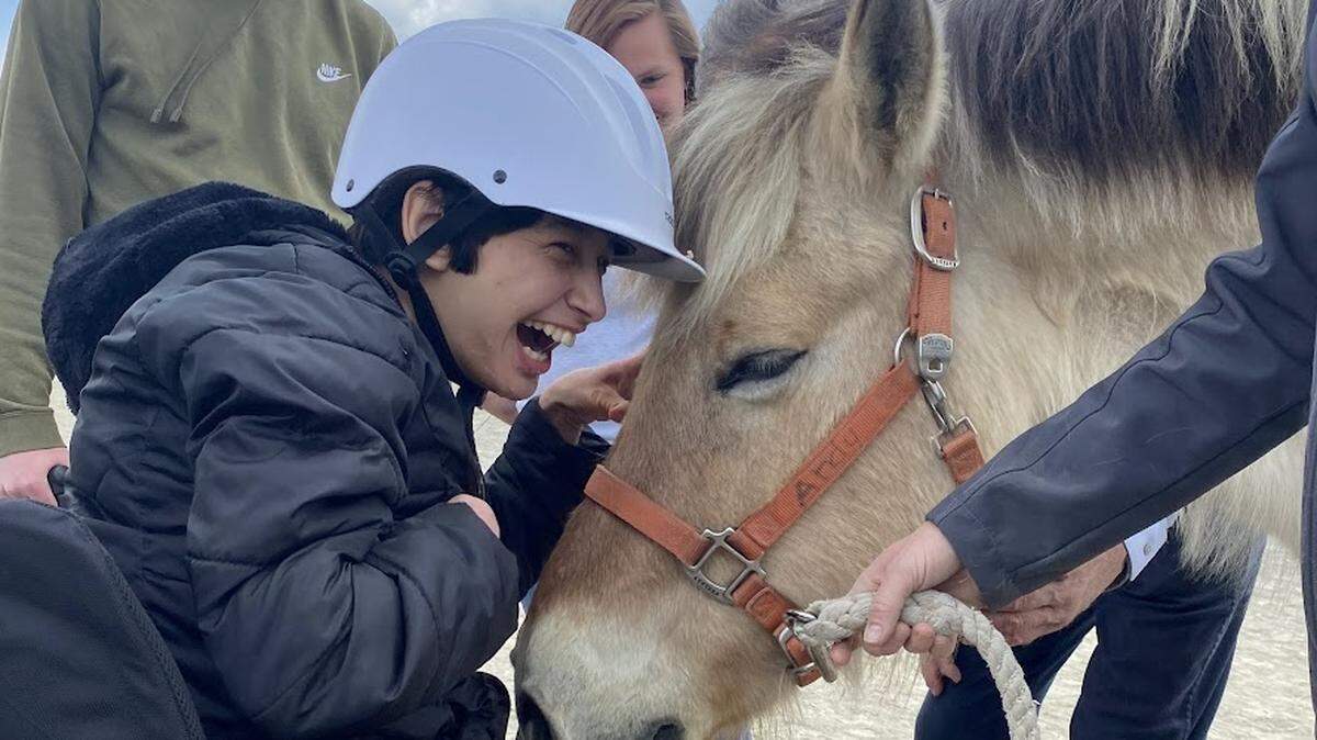 A rider participates in a Therapeutic Riding of Tri-Cities (TROT) program.