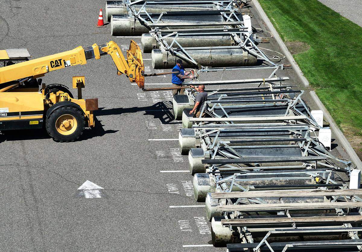 Workers reposition boat lifts in the parking lot next to the Columbia Park Marina after they were removed from the water while dismantling the boat docks at the facility in the west end of Columbia Park in Richland.