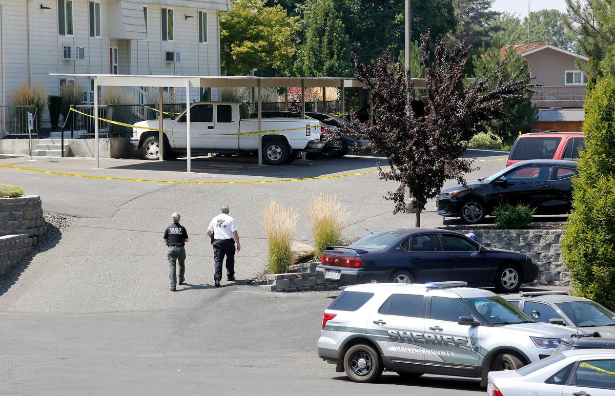 Investigators collect evidence from the parking lot of the Canyon Park Apartments in Prosser in August 2019 when Prosser officer Antonio Bustamante was shot in the leg chasing a suspect as police were responding to a burglary and shooting report. 