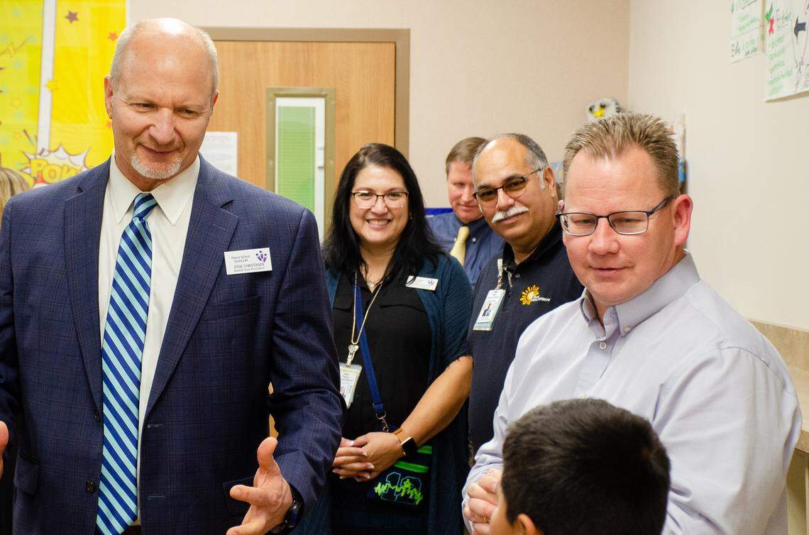 Pasco School Board Vice President Steve Christensen, left, and Washington Superintendent Chris Reykdal, right, speak to a fourth-grade student in Ms. Magana’s two-way dual language class during a Friday visit. Reykdal stopped by five Pasco schools during a visit that focused on dual-language learning and the district’s Bilingual Educators Initiative Teaching academy.