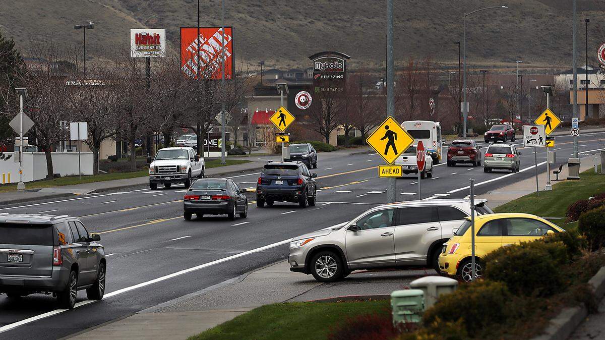 Traffic moves through the retail corridor on Duportail Street near Queensgate Drive recently in south Richland. The Richland City Council recently voted to raise transportation impact fees, the fees developers pay to support road construction to handle the new demand they create.