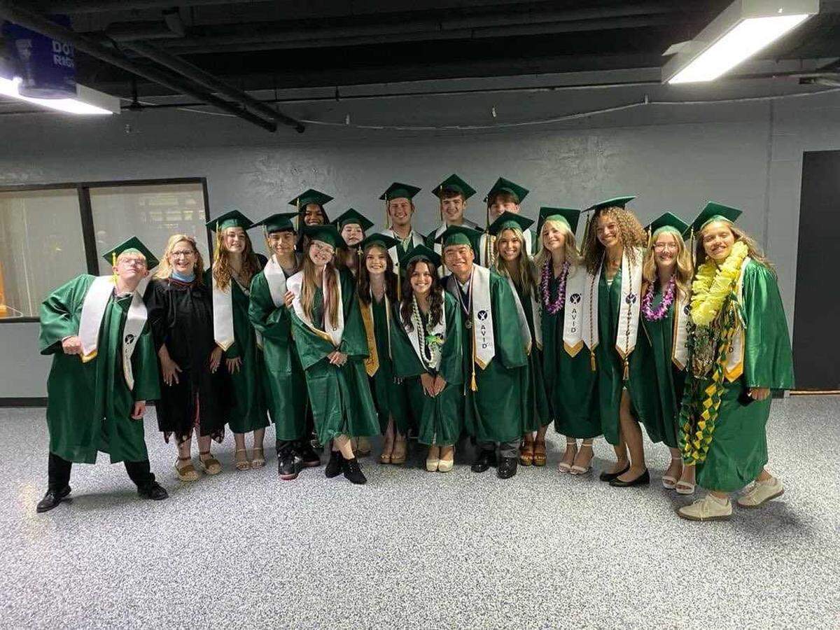 Erika Meneni, fifth from left, poses for a photo Friday, June 7, with her fellow AVID students at Richland High School’s 2024 commencement.