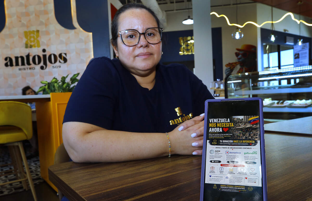 Aryelis Rojas, owner of Antojos 509 restaurant in Kennewick, discusses her efforts to raise money for Venezuelan organizations supporting people impacted by the recent earthquakes. Her smartphone screen displays a website dedicated to the relief efforts.