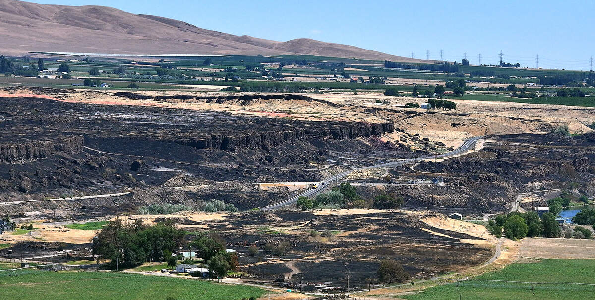 Fire damaged farm equipment and structures are visible on Schab Lane off Old Inland Empire Highway near Benton City after the June 14 fire.