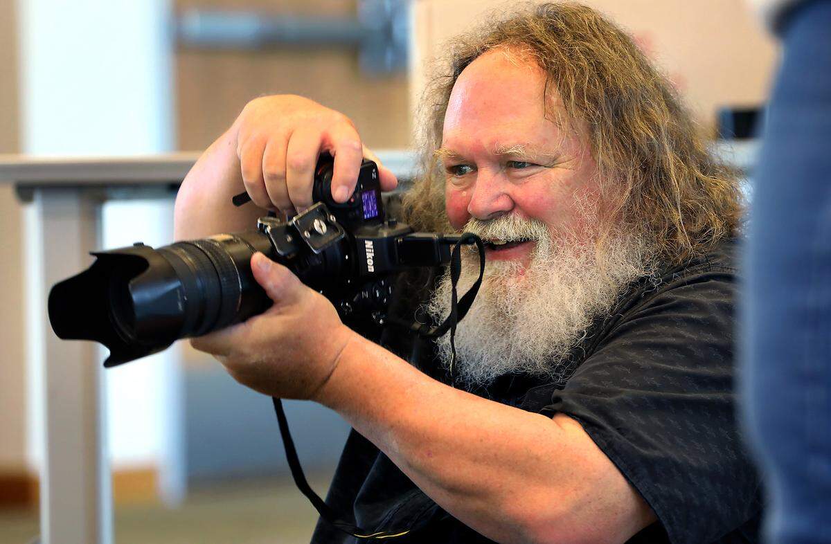 Photographer Scott Butner takes free portraits of residents in their Halloween costumes Friday morning at the Richland Public Library. It's a tradition he's done for 16 years. He's been averaging about 300 sittings a day for the past few years.