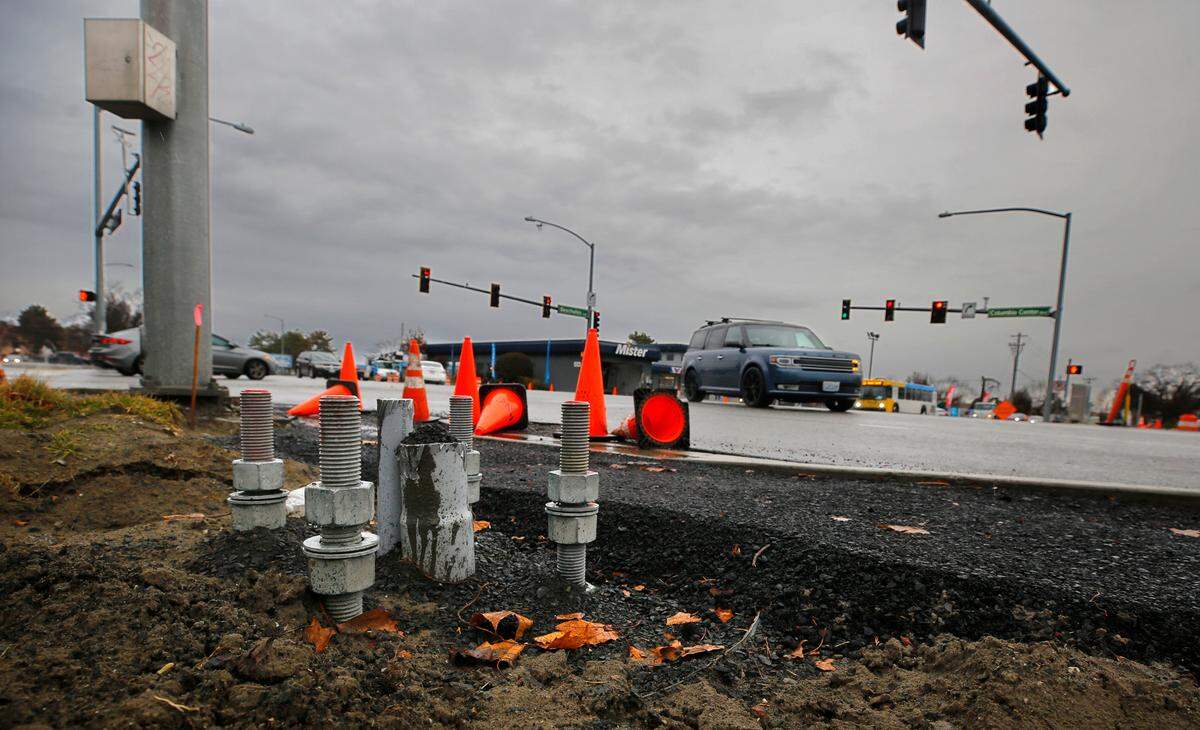 Anchor bolts for a traffic signal pole mounting plate stick out the ground at the intersection reconfiguration construction project at Columbia Center Boulevard and West Deschutes Avenue in Kennewick.