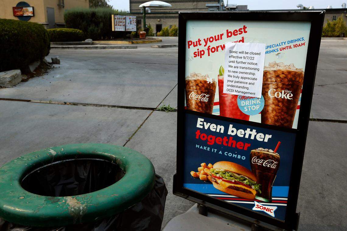 The entry to the Sonic Drive-In fast food restaurant off Gage Boulevard in Kennewick is blocked by garbage cans and a sign with a typed note announcing the closure of the business starting on Sept. 7.