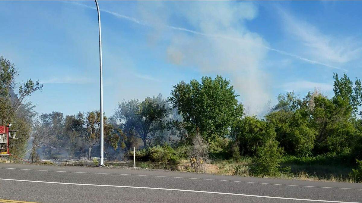 Firefighters battled a blaze that stretched more than a half mile behind Ice Harbor Drive Saturday afternoon.