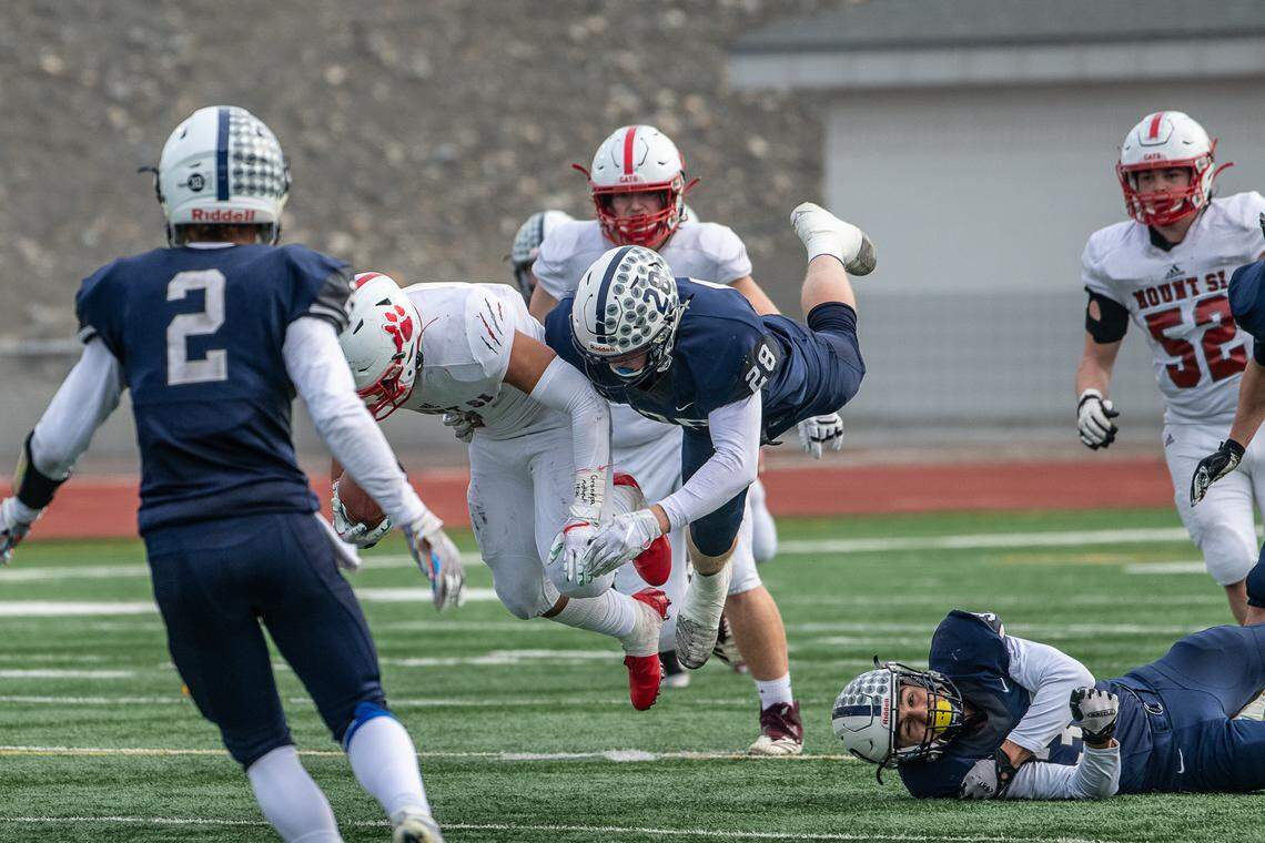 Chiawana’s Cameron Breier makes a flying tackle of Mount Si junior Cole Norah