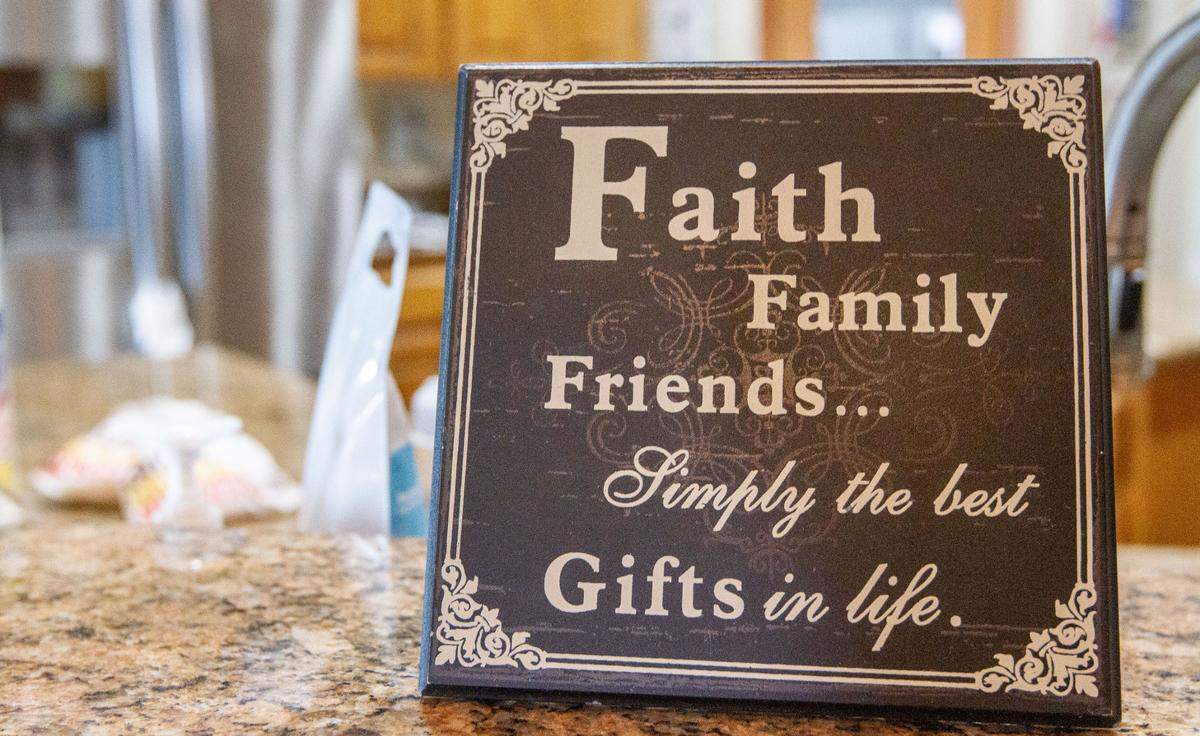A sign that Rita got in Boise sits on the kitchen counter of the Welch’s Pasco home as a reminder of the prayers from family and friends that they say got them through the months when Mike was in the hospital with a severe case of COVID-19.