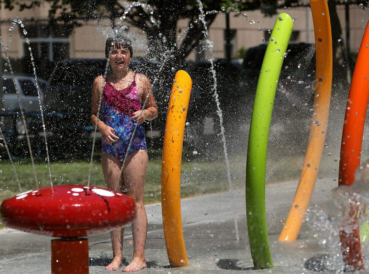 Lucy Chantel, 10, of Kennewick plays at Kennewick’s new splash pad water feature next the Kenneth Serier Memorial Pool at 315 W. 6th Ave. in downtown Kennewick.