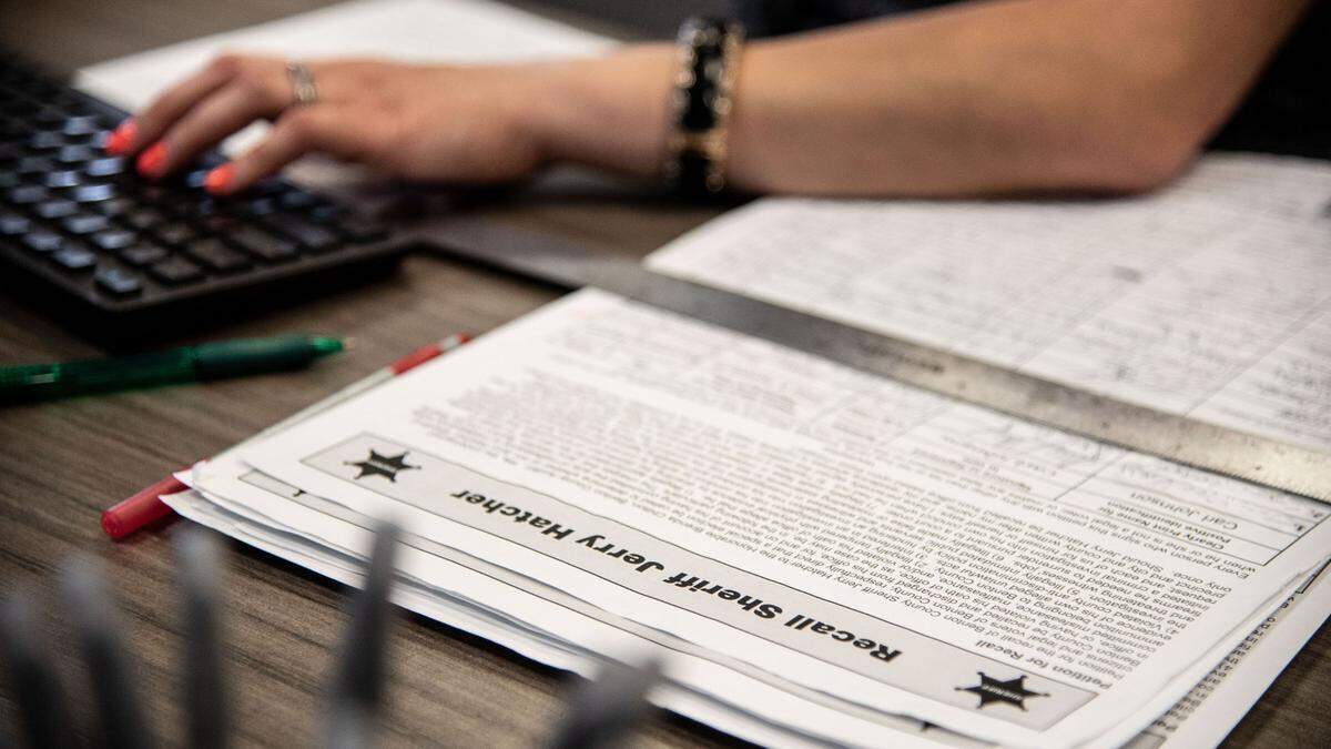 Myriam Gutierrez, supervisor of the Benton County auditor’s Prosser office, works to verify signatures on the “Recall Sheriff Jerry Hatcher” petition.