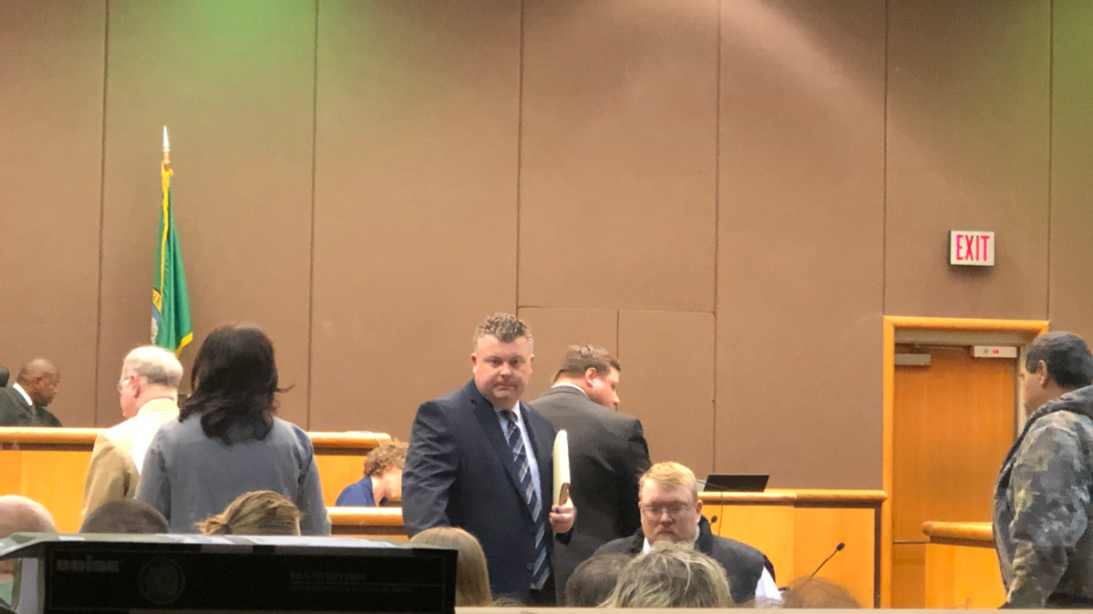 Christopher Lee Neal, seated in a wheelchair, leaves Benton County Superior Court after the disbarred lawyer admitted pocketing clients’ money instead of paying their owed back taxes or returning refunds. He is accompanied by his defense attorney, Scott Johnson.