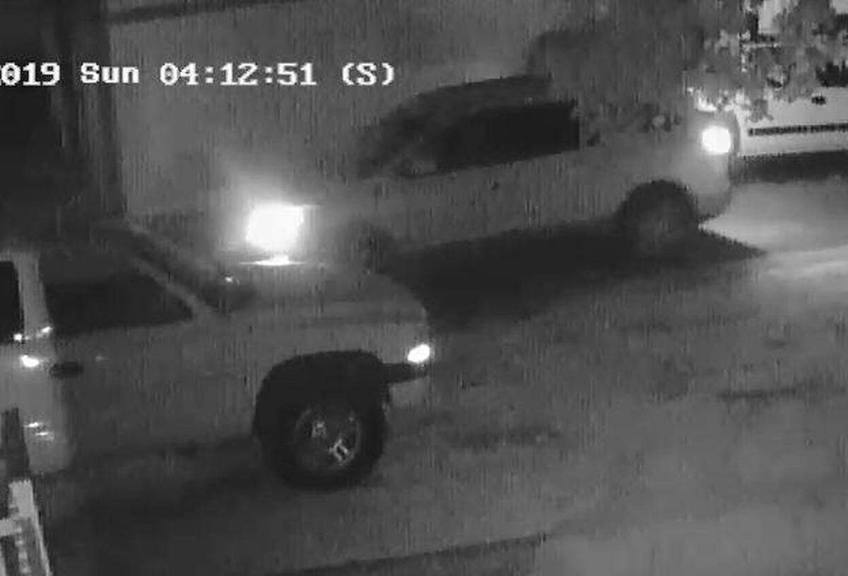 Kennewick police say the vehicle in the background, captured on home surveillance cameras, is connected with people of interest in Sunday’s gang-related homicide. The public is being asked to help identify the vehicle and its driver.