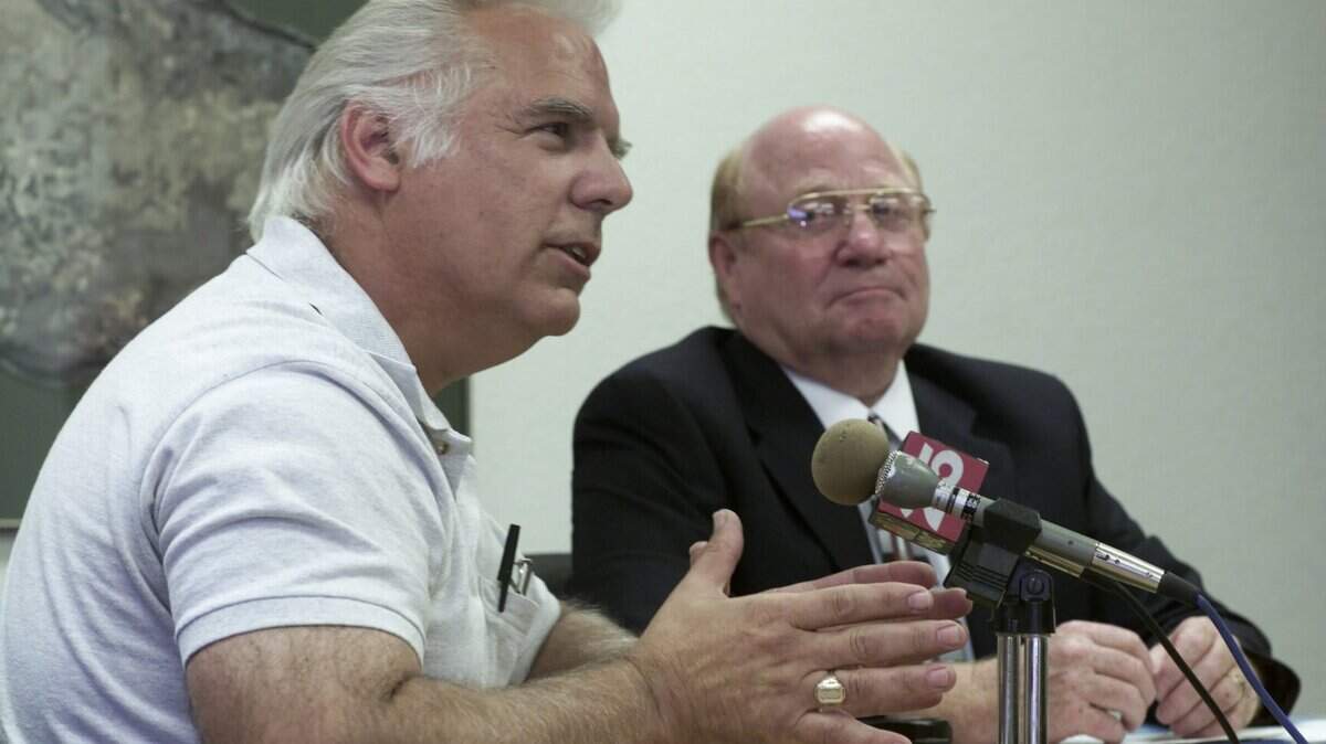 Benton County Fire Marshal Ken Williams, left, talks about homeowner fire protection Monday as Benton County Commissioner Leo Bowman looks on during a Benton County fire danger news conference in Richland in 2000.