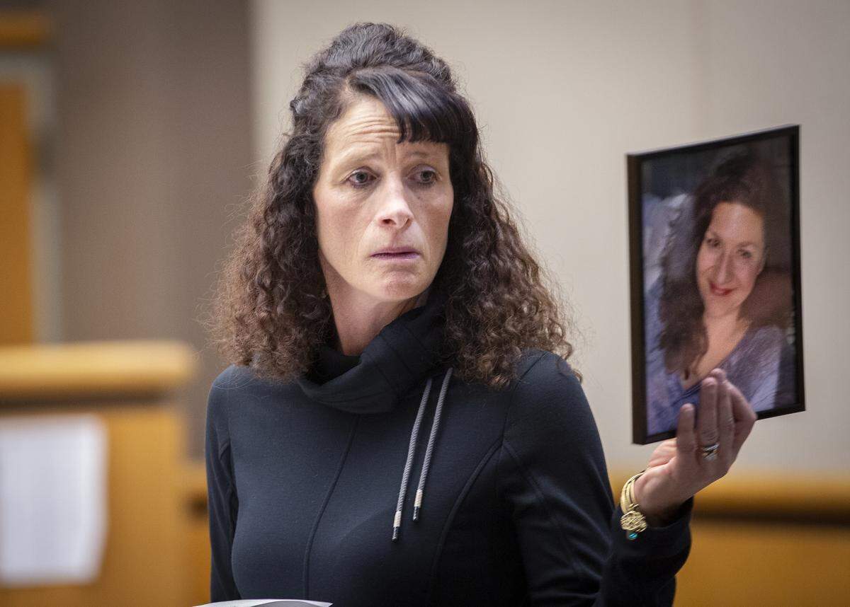 Meaghan Duly, a lifelong friend of Alisa Brewer, holds up a photo of Alisa as she reads a letter to Judge Jackie Shea Brown in Kennewick on Friday during the sentencing of William “Will” Lee.