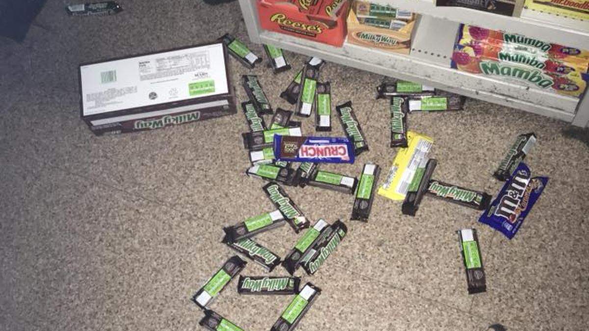 A burglar left a trail of candy bars behind him after a Dollar Store break-in Tuesday morning.