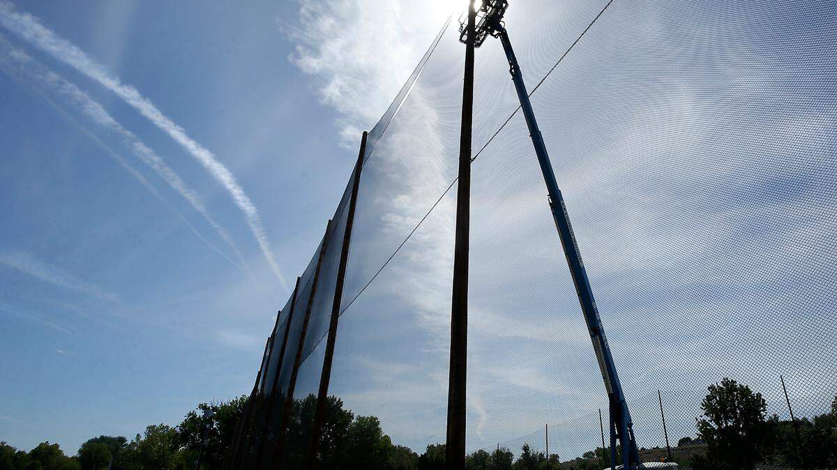 A worker uses a fully extended boom lift under Thursday’s sunny skies to reach upper attachment points while completing a safety net replacement project for the driving range at the Columbia Park Golf Tri-Plex in Kennewick. The sunny and warm conditions are expected to continue into early next week, according to the National Weather Service forecast. The high temperature is predicted to climb each day until peaking on Sunday at 91 degrees.