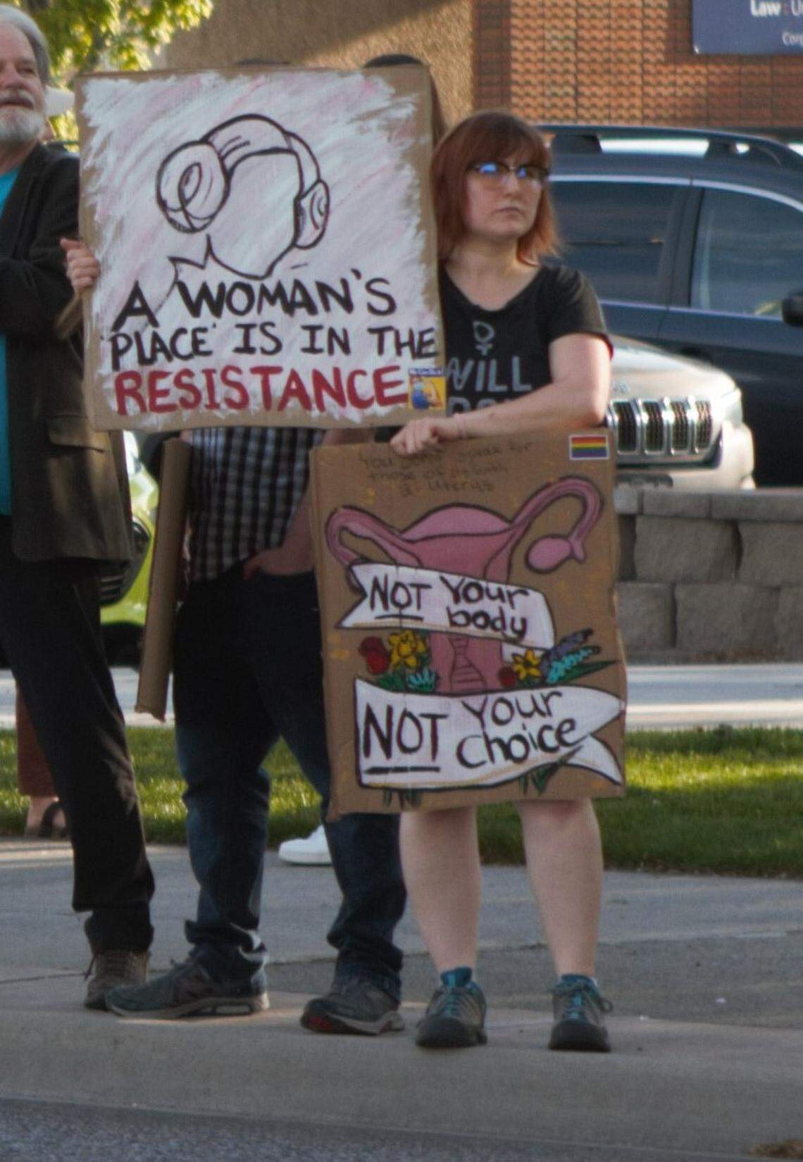 A protester supporting abortion rights at a Richland demonstration holds two signs, one reading “A woman’s place is in the resistance,” referring to the late Carrie Fisher and her iconic Star Wars character General Leia Organa. Hundreds demonstrated in Richland on May 4.
