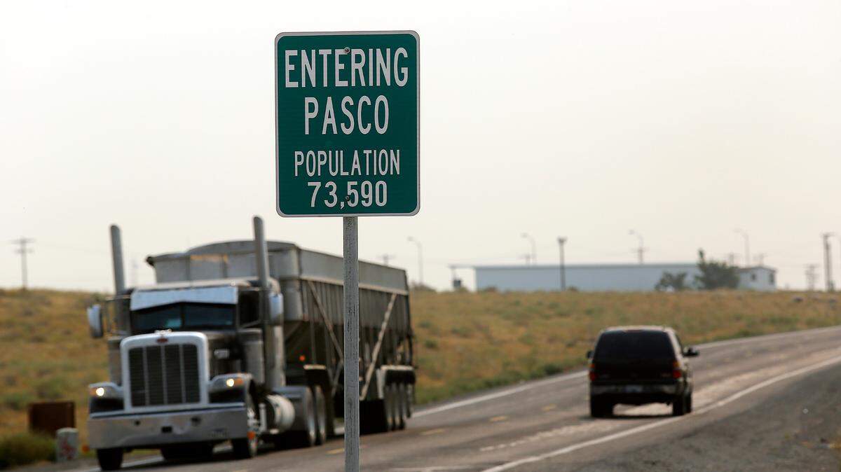 A sign on Glade Road North displays the population to drivers traveling south into the Pasco city limits from rural Franklin County.