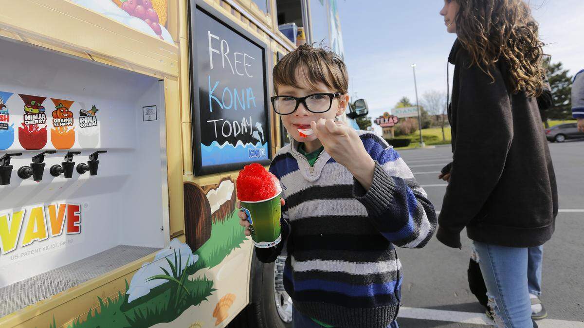 Prestyn Klinger, 7, grins while eating free shaved ice from Kona Ice of South Richland outside of Texas Roadhouse in Kennewick during its fifth annual "Chill Out" on tax day . Prestyn Klinger was accompanied by his cousin Alyssa Beidler of Kennewick.