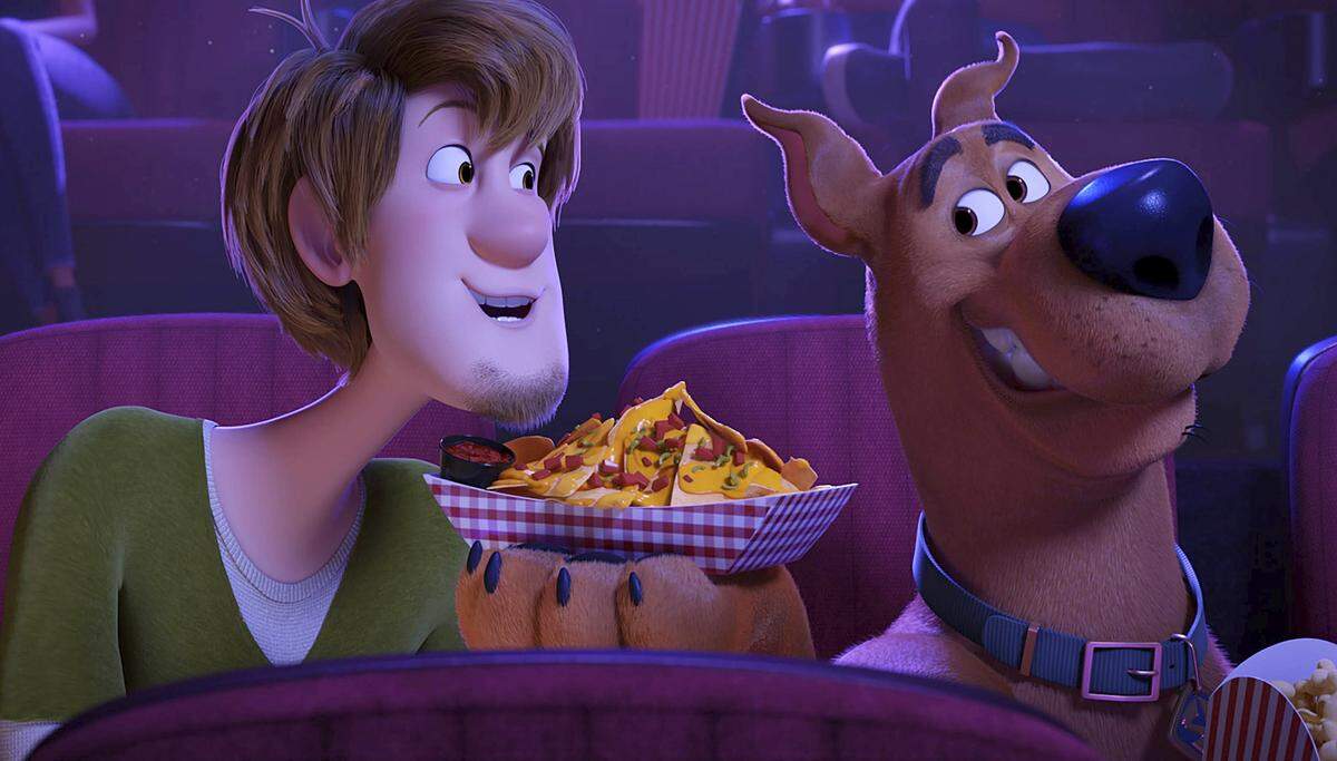 This image released by Warner Bros. Pictures shows characters Shaggy, voiced by Will Forte, left, and Scooby-Doo, voiced by Frank Welker, in a scene from the animated film “Scoob!” The Scooby-Doo film will bypass theaters and premiere directly on digital platforms, Warner Bros. said Tuesday, making it the latest studio to experiment with an on-demand release during the pandemic shutdown.