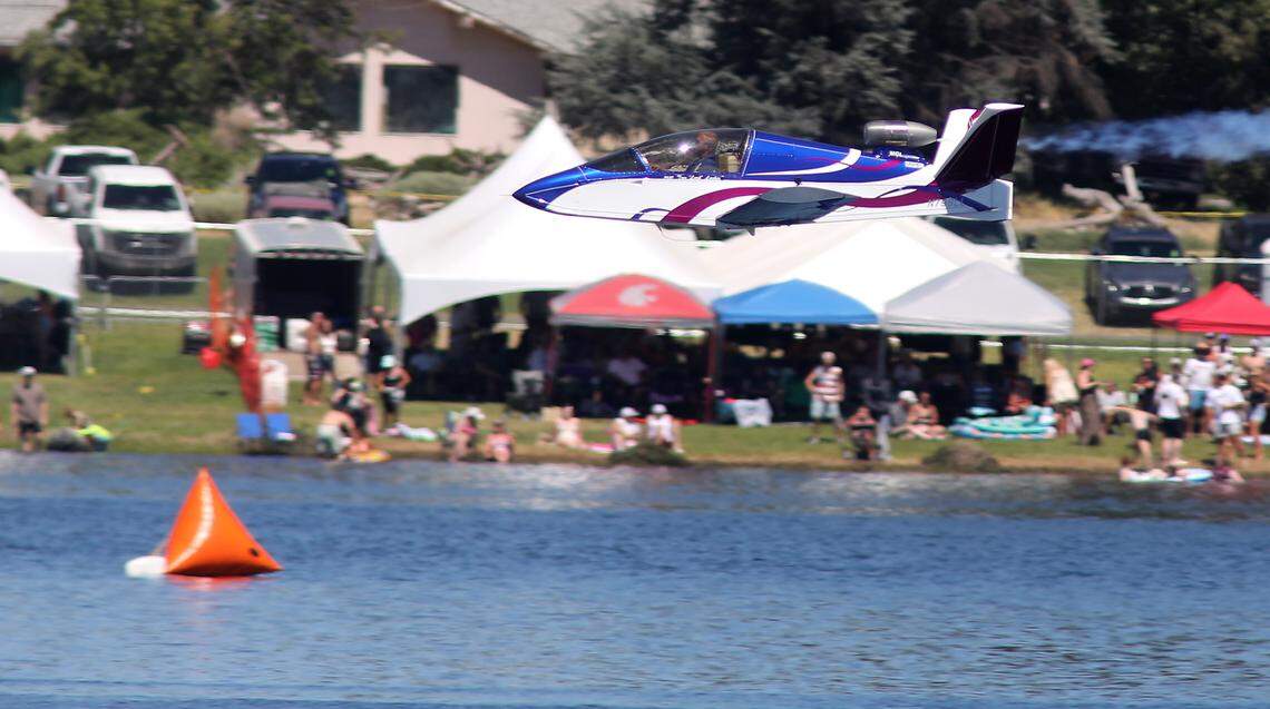 Pilot Tom Larkin screams past the fans on the Franklin County shoreline of the Columbia River in his highly modified SubSonex Jet. The mini jet weighs only 500 pounds, is fully aerobatic and capable of reaching 300 mph.