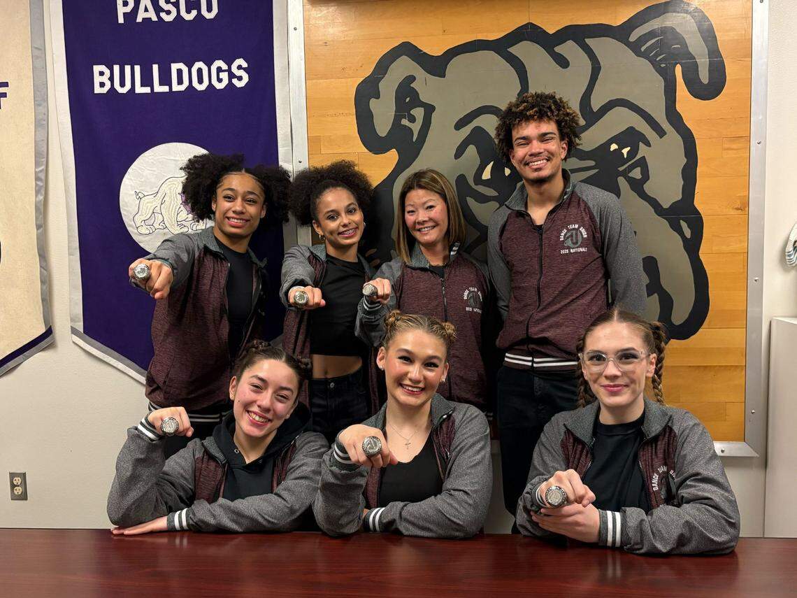The six members of the Pasco High School dance team that brought home the number one trophy pose with their coach, Becca Schwan, sporting their Dance Team Union National Champion rings and jackets.