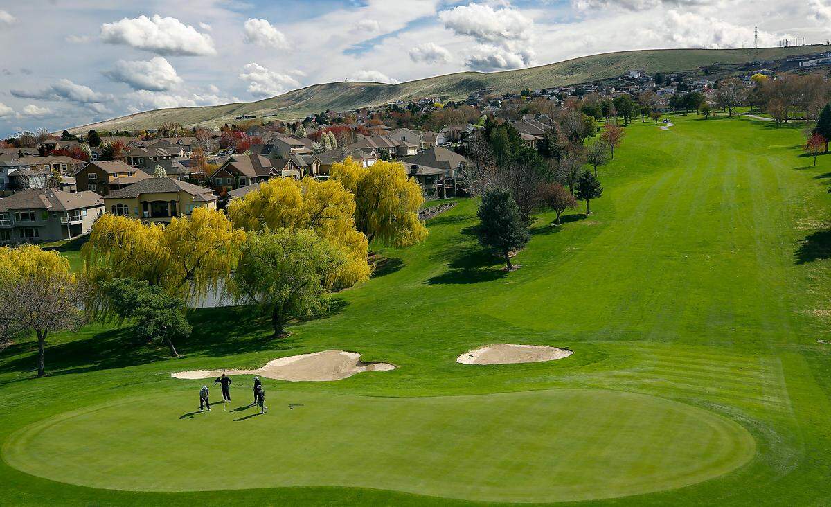 Golfers putt to finish their round of golf on the 18-hole Canyon Lakes Gold Course of the Kennewick course at 3700 W. Canyon Lakes Dr.