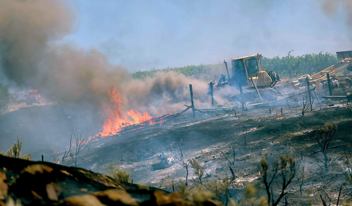 A fire is burning near 388 PR NE east of Benton City. The fire has threatened homes, vineyards and orchards.